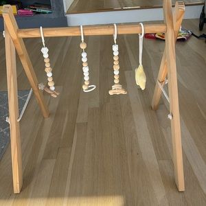 Wooden baby gym. Accessories included.